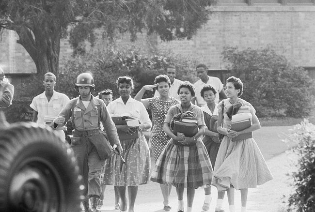 The Little Rock Nine Black alunos deixam Little Rock, Arkansasâ € ™ Central High School depois de terminar mais um dia letivo.