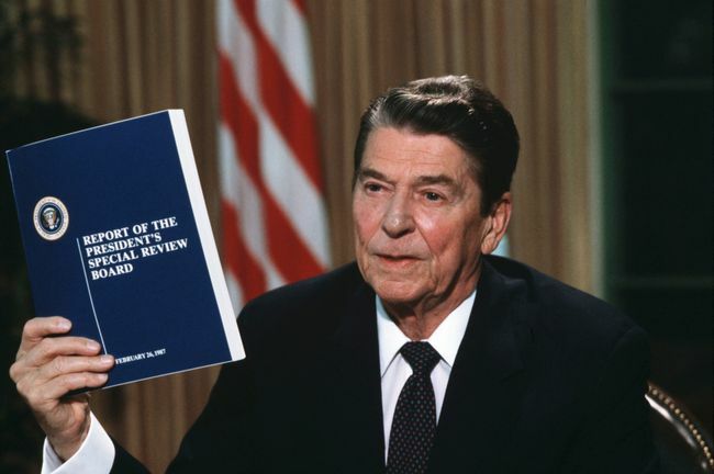 O presidente Ronald Reagan segurando uma cópia do relatório da Tower Commission sobre o escândalo Irã-Contra