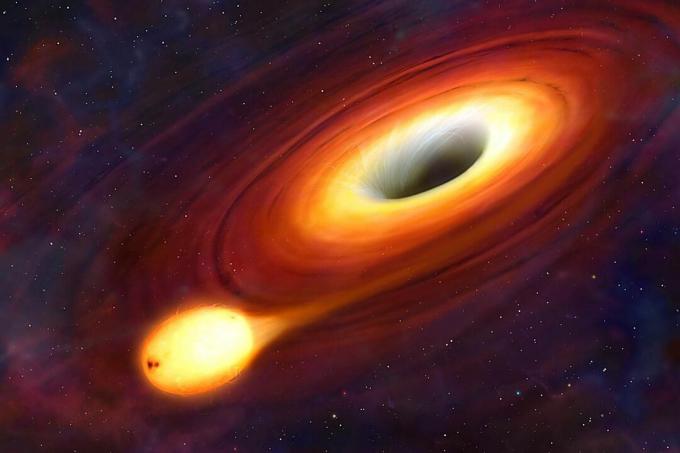 Um buraco negro é um objeto tão compacto que nada pode escapar de sua atração gravitacional. Nem luz. Na Terra, um objeto precisa ser lançado com uma velocidade de 11 km / s para escapar da gravidade do planeta e entrar em órbita. Mas a velocidade de escape de um buraco negro excede a velocidade da luz. Como nada pode viajar mais rápido que essa velocidade máxima, os buracos negros sugam tudo, incluindo a luz, o que os torna totalmente escuros e invisíveis. Nesta imagem, podemos ver um buraco negro, mas apenas porque é cercado por um disco superaquecido de material, um disco de acréscimo. Quanto mais próximo do furo o material fica, mais e mais luz é capturada, e é por isso que o buraco fica mais escuro em direção ao centro.